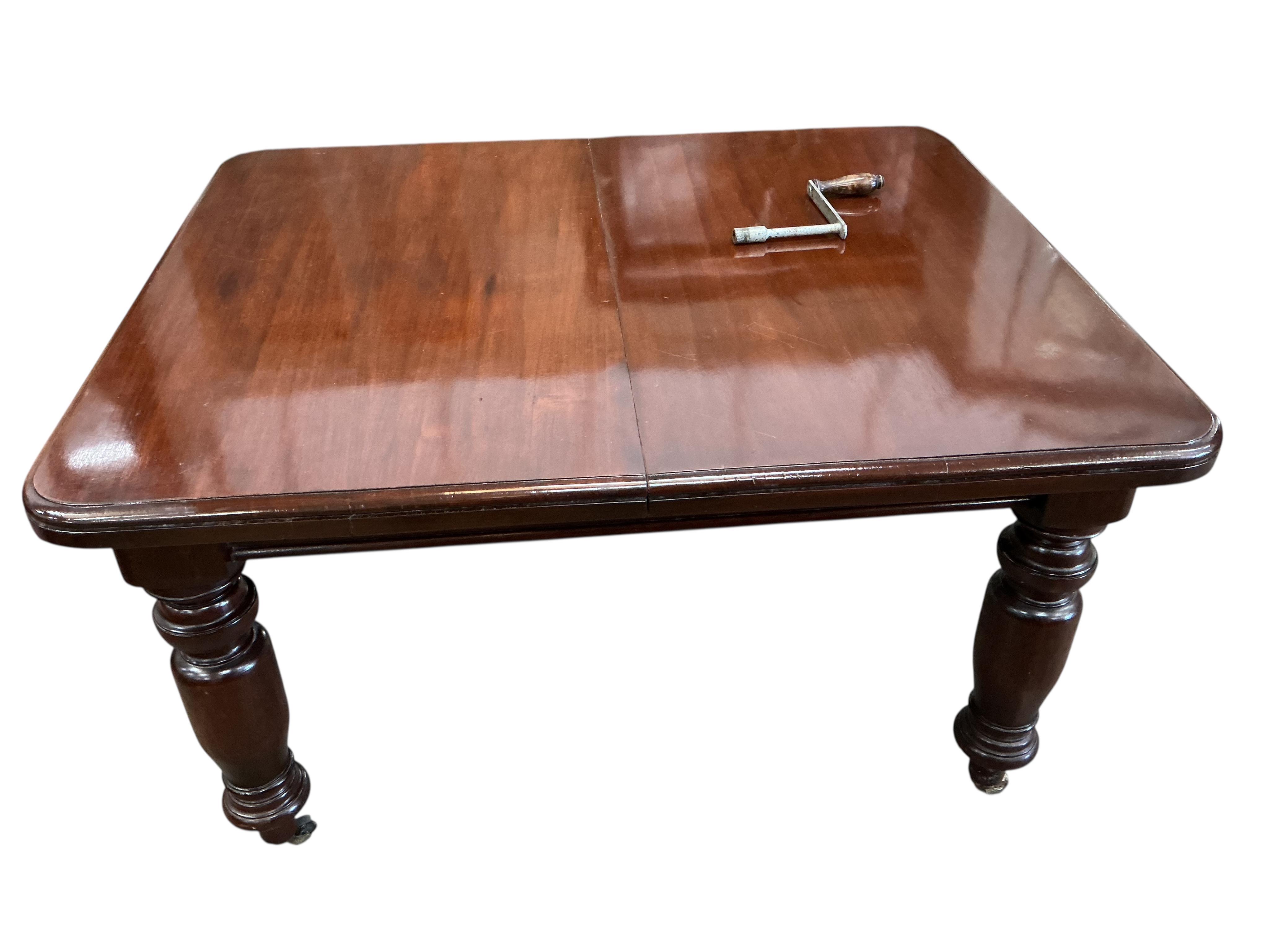 A Victorian style mahogany extending dining table, width 226cm extended, two spare leaves together with a set of eight Chippendale Revival mahogany dining chairs, two with arms